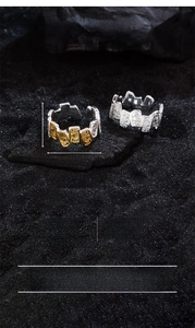 Macro detail of vintage flame texture on open copper rings in silver and gold finish