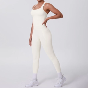 Detail view of ivory white yoga set showing racerback sports bra and leggings with side pocket