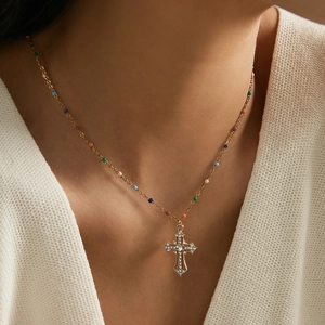 Gold stainless steel cross necklace with colorful beads and white crystal inlay on a model