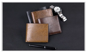 Detailed view of four leather wallets in various brown tones with a watch and pen