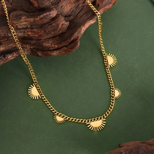 Chic 18K gold plated titanium necklace with sunburst sun pendants on green background