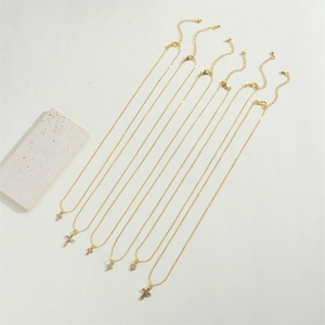 Detailed view of gold cross pendants with vibrant colorful cubic zirconia on dainty chains