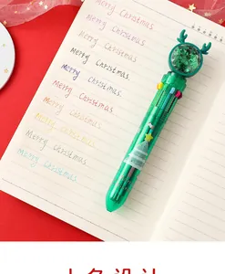 Close-up of 10-color Christmas ballpoint pen with reindeer topper and festive patterns