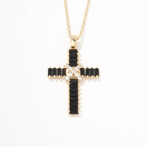 Detailed close-up of a gold cross pendant necklace with black and white zircon stones
