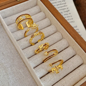Macro detail of gold-plated pony rings with enamel coating and zircon stones