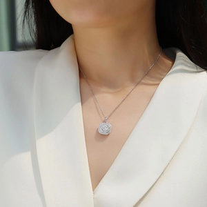 Detail view of a square S925 silver pendant with moissanite on a female model