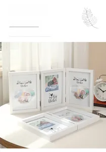 Close-up of white wooden folding picture frame with 5x7 inch baby themed art display