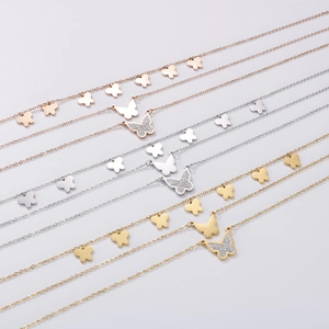 Detail showing multi-layer butterfly necklaces in rose gold, silver, and gold finishes
