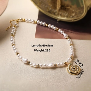 Detail of pearl necklace with golden nautilus pendant and 40 plus 5cm length specs
