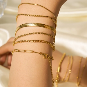18k gold plated stainless steel snake and cuban link bracelets worn by a model