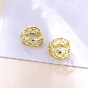 Golden hollow four-leaf clover hoop earrings in minimalist style on white background