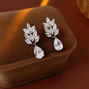 Detailed macro view of silver stud earrings with marquise cut cubic zirconia leaf shape