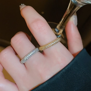 Close-up of gold and silver plated twist rings with pavé cubic zirconia on fingers