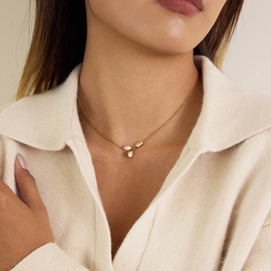 Detail of 18K gold-plated necklace featuring teardrop and marquise zircon pendants