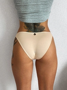 Close-up back view of beige cotton sporty briefs showing soft fabric texture and seamless fit