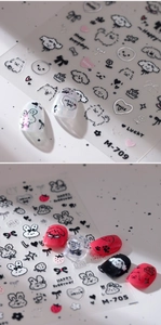 Detailed view of self-adhesive nail stickers with cute cartoon dogs and hearts