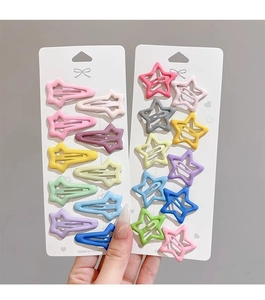 Detail showing assorted colorful star-shaped and water drop metal snap hair clips for girls