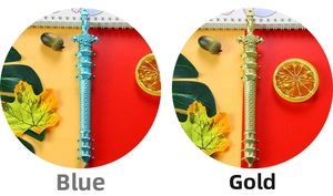 Detailed close-up of vintage sword-shaped pens in gold and blue with embossed textures