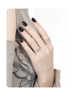 Close-up of S925 silver rings with geometric crystals on a model hand with black nails