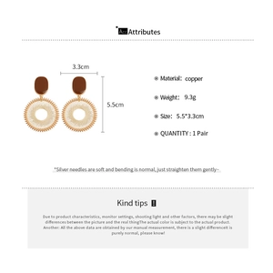 Detailed view of woven hoop earrings with size specifications and material info