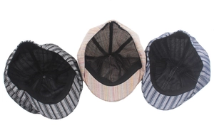 Detail view showing multi-panel stitched interior lining of striped cotton newsboy caps