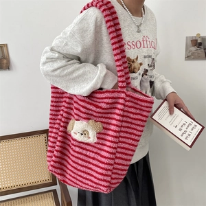 Close-up of pink striped plush tote bag featuring a cute cartoon dog applique