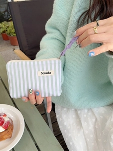 Portable striped canvas cosmetic bag in green and white with a purple wrist strap