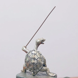 Detail of vintage turtle incense burner holder with rustic texture and antique finish