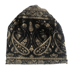 Ethnic paisley print knit beanie hat with golden pattern on black background for adults