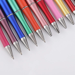 Colorful DIY beaded pens in gradient macaron shades with metallic tips on grey background