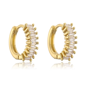 Detail of gold-plated huggie earrings with baguette-cut cubic zirconia and polished finish