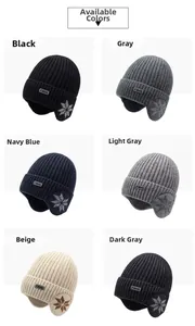 Detail view of knit beanies with ear flaps in six colors featuring snowflake patterns
