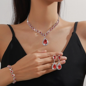 Detailed view of red pear-shaped rhinestone jewelry set including necklace and earrings