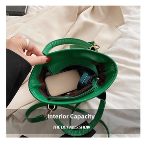 Internal view of green tote bag showing zipper pocket and daily essentials storage