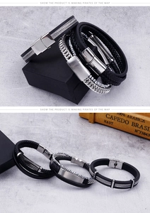 Detailed view of men's multilayer braided leather and stainless steel chain bracelets