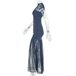 Close-up of ruched side details and sheer black mesh hem on this slim-fit evening dress