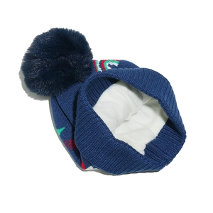 Close-up of winter knit hat featuring warm white fleece lining and soft blue faux fur pom