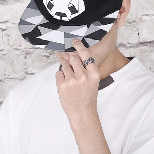 Détail d'une bague argentée pour homme avec motif géométrique creux portée au doigt