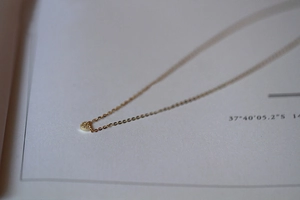 Macro shot of 925 sterling silver mini heart pendant necklace with cubic zirconia