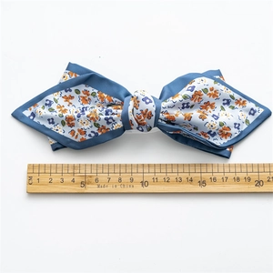 Elegant 17cm blue floral satin bow hair clip with spring fastener shown with ruler