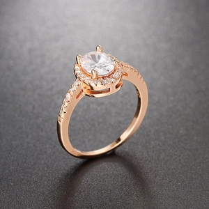 Macro shot of rose gold engagement ring with oval-cut zircon and pavé diamond setting