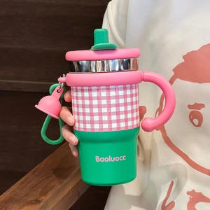 Pink and green stainless steel insulated coffee tumbler with handle and straw accessory