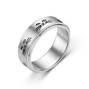 Detailed view of brushed stainless steel ring featuring engraved minimalist cat face patterns