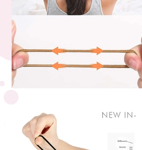 Close-up showing the strong elasticity and stretching of brown and black hair ties