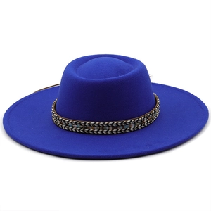 Close-up of royal blue wide brim felt hat with intricate woven vintage decorative band