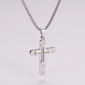 Detailed macro view of vintage silver cross pendant with fine textured engravings