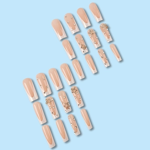 Long white French press-on nails with star rhinestones on a light blue background
