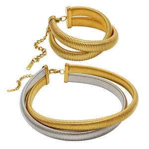 Detail showing two-tone gold and silver chunky snake chain necklaces and matching bracelet