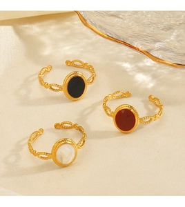 Detail view of oval geometric rings with woven bands and colorful enamel on silk