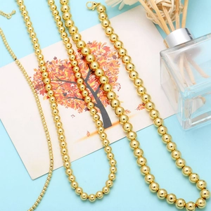 Macro shot of gold bead necklaces in four sizes with high-polished finish and lobster clasp